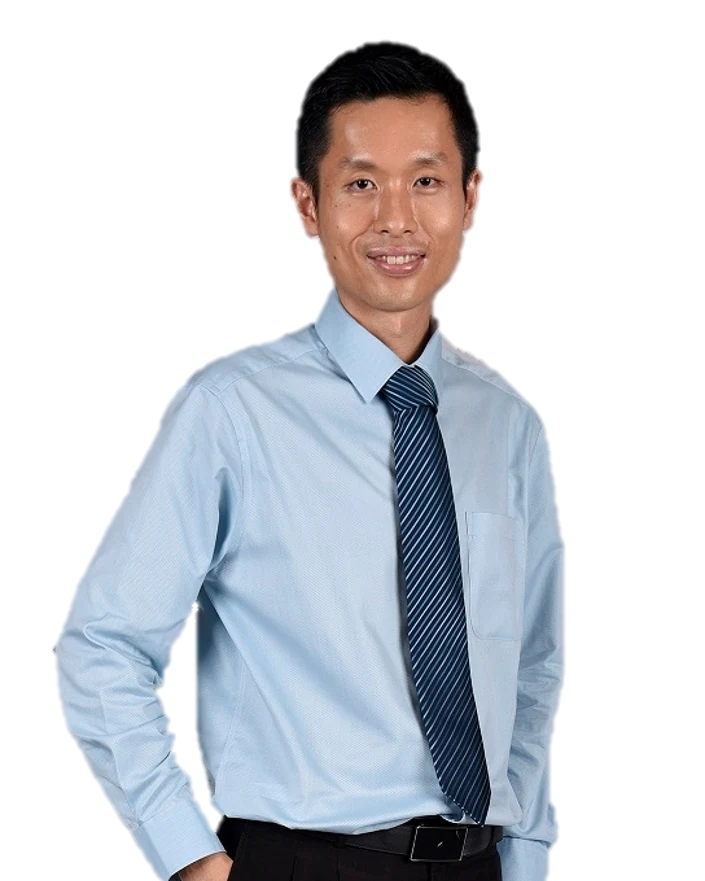 Portrait of Dr Eugene Tan, smiling, in a light blue shirt and striped tie